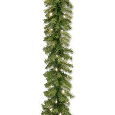 a christmas garland with lights hanging from it's side on a white wall background