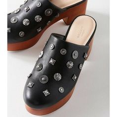 Infuse your modern look with ‘70s-inspired style in this embellished faux leather clog, available exclusively at UO. Mule clog with a rounded toe, made in a faux leather with metal stud embellishments scattered allover. Set on a wooden platform and block heel with rubber coating. Content + Care - Polyurethane, wood, rubber - Spot clean - Imported Size - Heel height: 3” - Platform height: 1” Studded Clogs, Thrift Flips, Black Clogs, Leather Clog, Shoe Fits, Leather Clogs, 70s Inspired, Up Shoes, Fashion Vintage