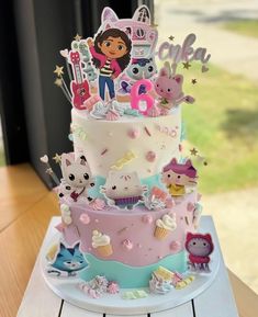 a three tiered cake with cartoon characters on it