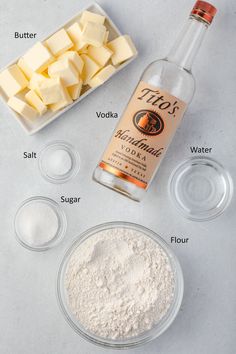 ingredients needed to make cheesecakes on a counter including butter, flour and sugar