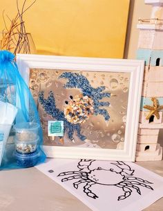 some items are sitting on a table next to a blue bag and an art piece