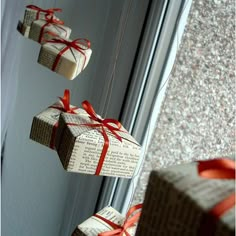 three wrapped presents hanging from strings on a door