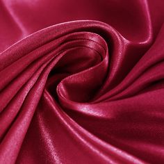 a close up view of a red satin fabric