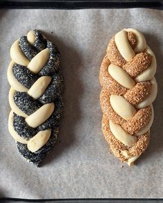 three different types of pastries are on a baking sheet, one is filled with sesame seeds and the other has almonds