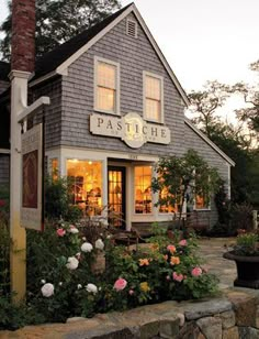 a small house with flowers in front of it and the words pasteiche written on the door