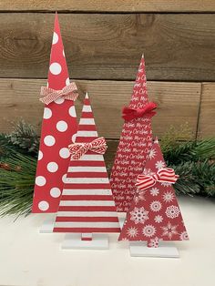 three red and white christmas trees with bows