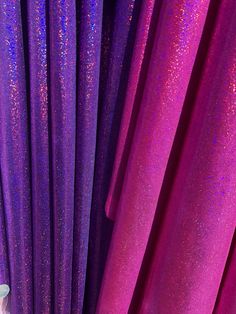 purple curtains are lined up next to each other