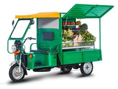 a small green truck with fruits and vegetables in it's side car on a white background