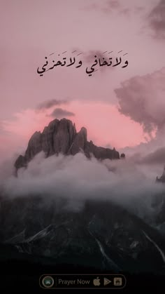 the mountains are covered in clouds with arabic writing