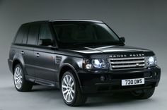 a black range rover parked in front of a gray background