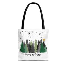 a tote bag with the words happy holidays on it and pine trees in the background