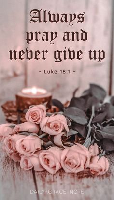 a candle and some roses on a table with the words, always pray and never give up