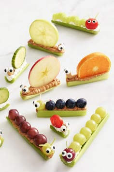 various fruits and vegetables are arranged in the shape of caterpillars with eyes on them