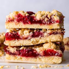 three strawberry crumb bars stacked on top of each other