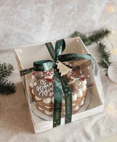 a box that has some cupcakes in it on a table with christmas decorations