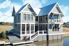 a large house sitting on top of a body of water next to a boat dock