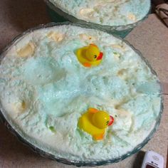 two bowls filled with rice and yellow rubber ducky toy ducks sitting on top of it