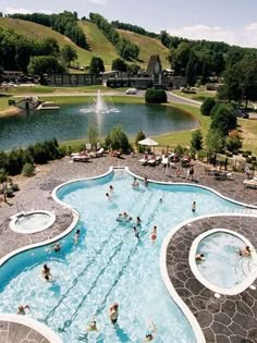 an outdoor swimming pool with people in it