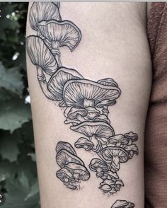 a woman's arm with mushrooms on it