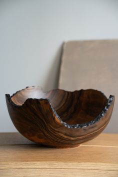 a wooden bowl sitting on top of a table