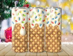 three milkshakes decorated with sprinkles and christmas decorations