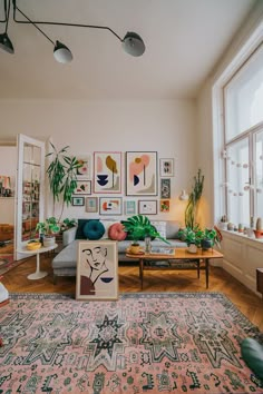 a living room filled with furniture and lots of plants