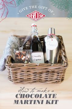 the chocolate martini kit is in a wicker basket on a table with pine branches