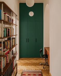 a room with bookshelves and a rug on the floor