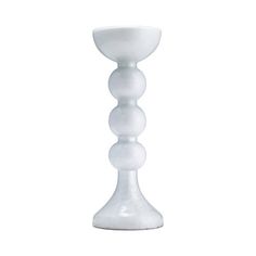 a tall white glass candle holder on a white background with no one around it to see the light