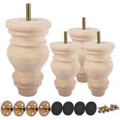 four wooden knobs and two screws are shown in front of each other with gold hardware