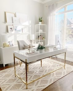 a living room with white furniture and gold accents