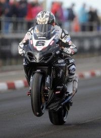 a person riding a motorcycle on a race track