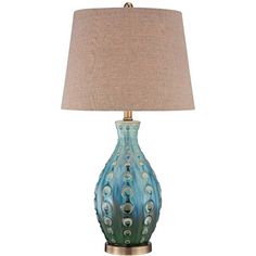 a blue lamp with a brown shade on it and a beige linen lampshade