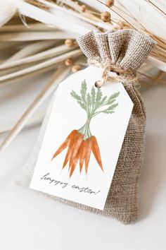 a bag with a tag that says happy easter on it next to some stalks of wheat