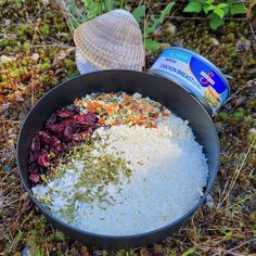 rice, cranberries, and other ingredients are in a bowl on the ground