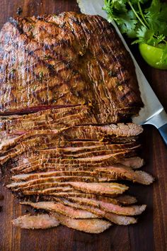 the meat is sliced up and ready to be served on the grilling board, with parsley next to it