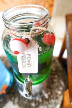 a glass jar filled with liquid sitting on top of a table