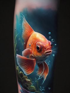 a goldfish tattoo on the leg of a person's leg with water and bubbles