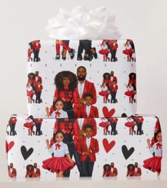 two presents wrapped in white wrapping paper with black people on them and red heart shapes