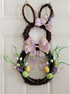 an easter wreath is hanging on the front door