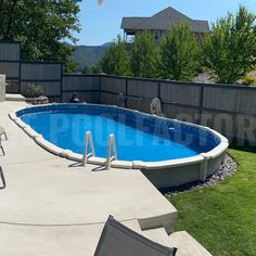 an above ground pool surrounded by lawn chairs