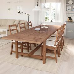 a large wooden table sitting in the middle of a living room