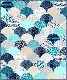 a blue and white quilt with circles on it