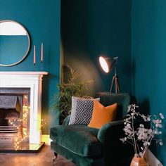 a living room filled with furniture and a fire place next to a mirror on the wall