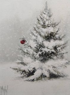 a snow covered tree with a red ornament on it