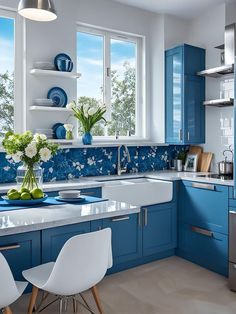 a kitchen with blue cabinets and white chairs