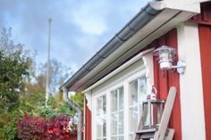 the ladder is leaning against the red house