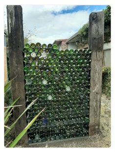 a wooden gate made out of empty wine bottles