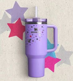 a purple travel mug with stars on the side and a straw sticking out of it