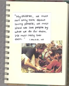 an open notebook with a note attached to the page and a photo of people around it